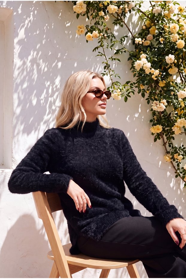 Women's black plush sweater with feather detail and half-fishtail slit