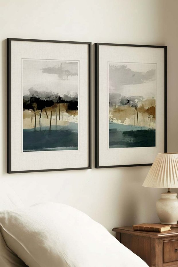 2 VINTAGE PAINTINGS WITH BLACK WOODEN FRAMES FEATURING A SERENE HORIZON CONCEPT
