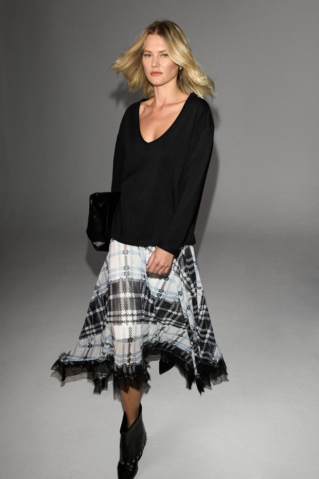 Avalyn women's plaid patterned skirt with lace trim, asymmetrical hem, and mesh pattern.