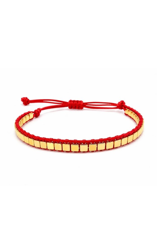 Red cord elevator bracelet with gold detailing.