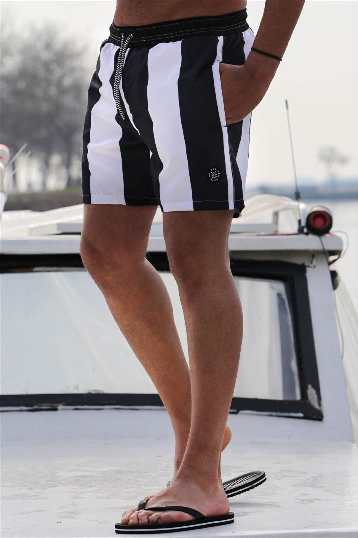 Mens black and white striped swim trunks top