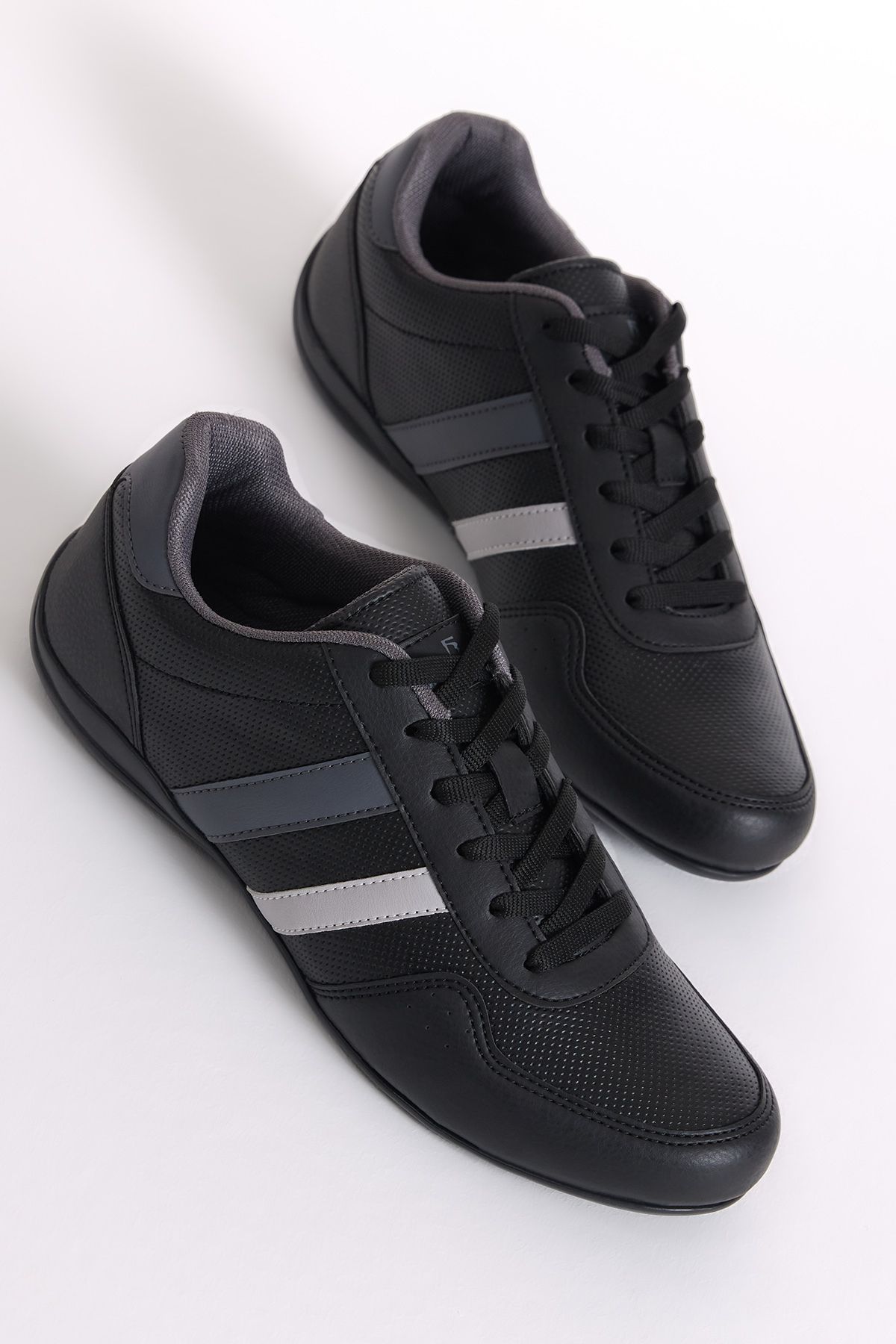Black trainers with white stripe hot sale