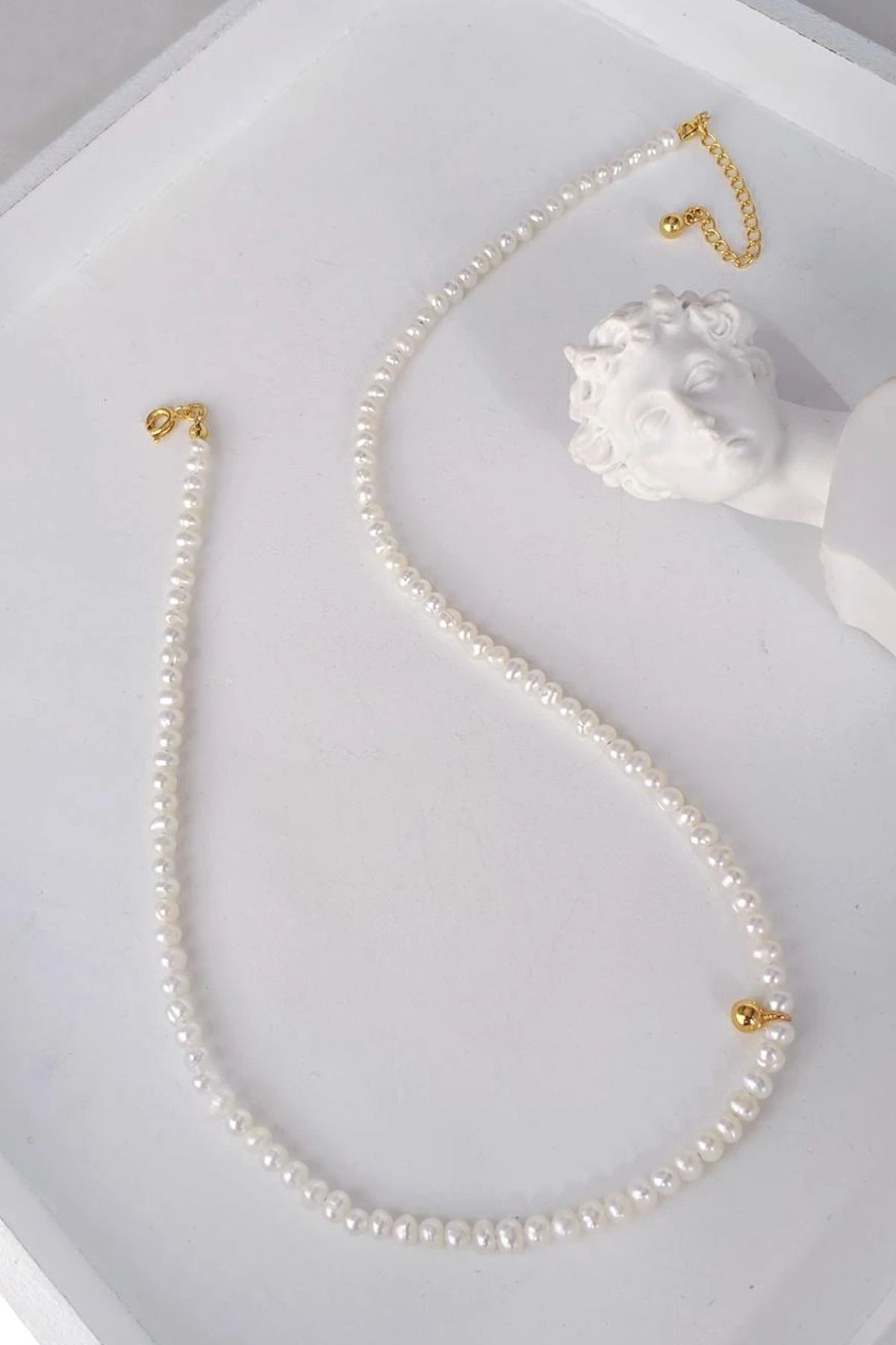 White pearl shop necklace with gold