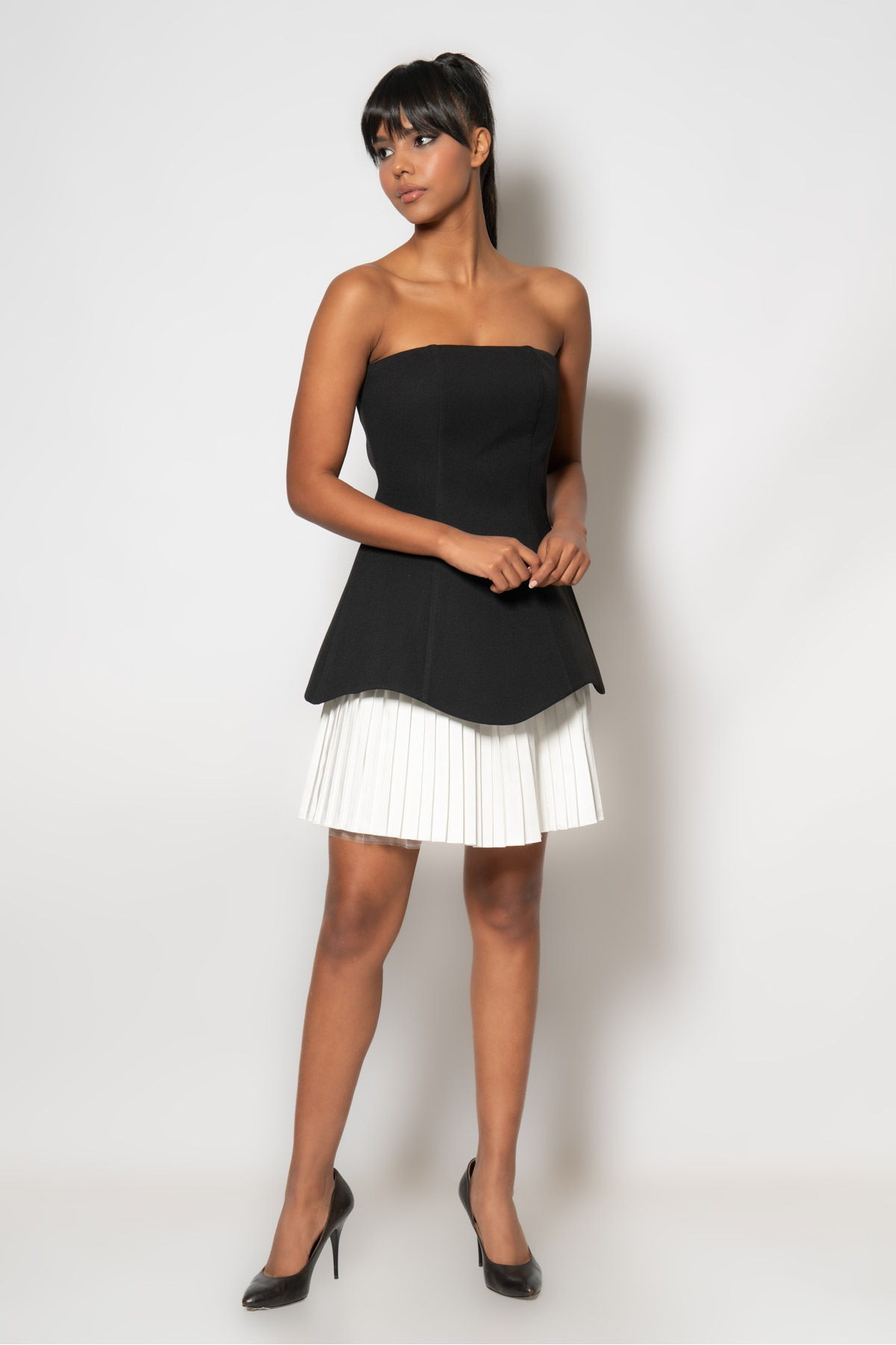 Strapless crepe evening dress with satin pleated bell skirt at the hem