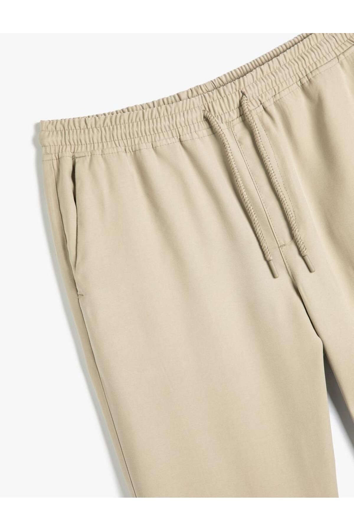 شلوار گاباردین با دور کمر توری و جزئیات جیب