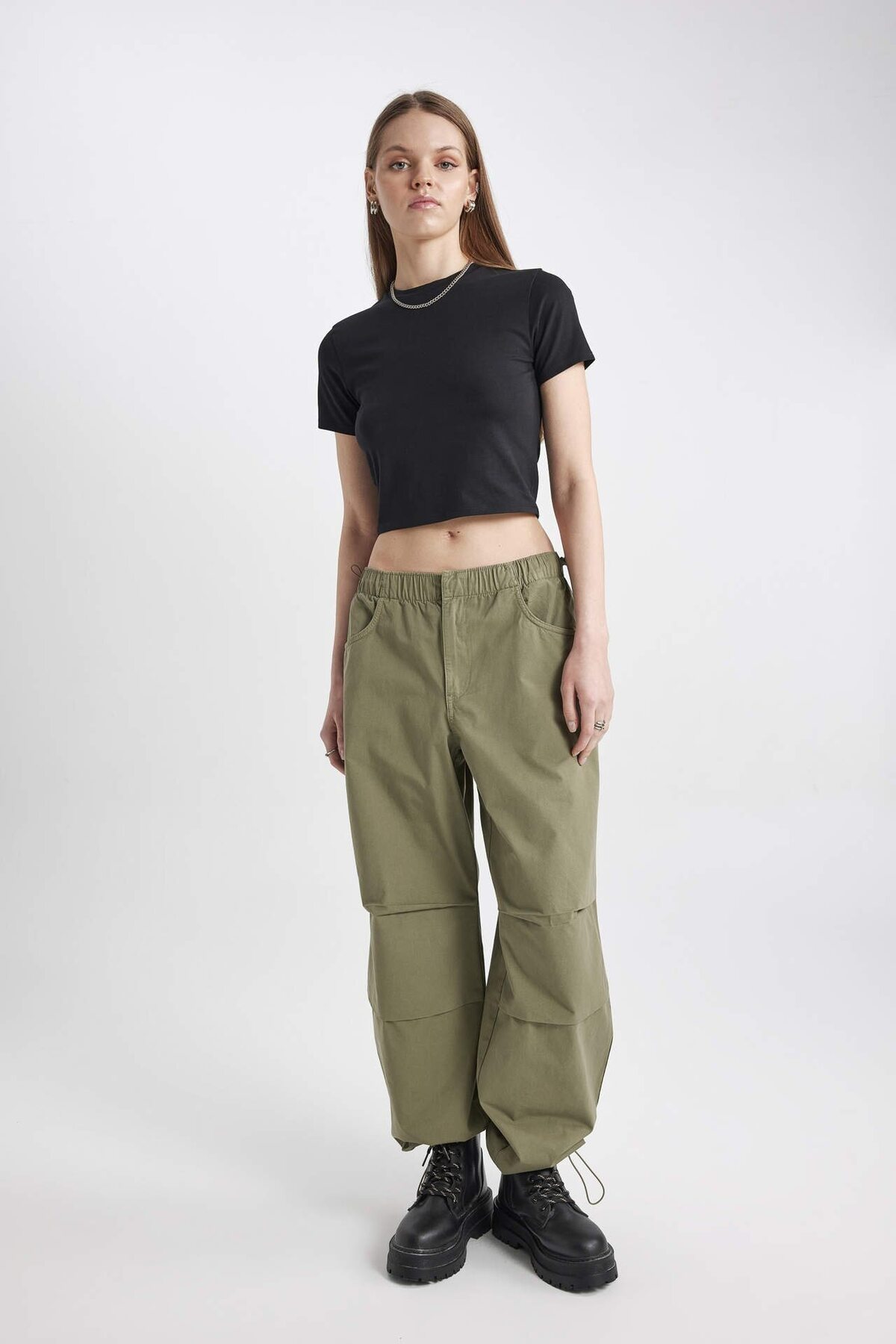 Black fitted T-shirt styled with olive cargo pants