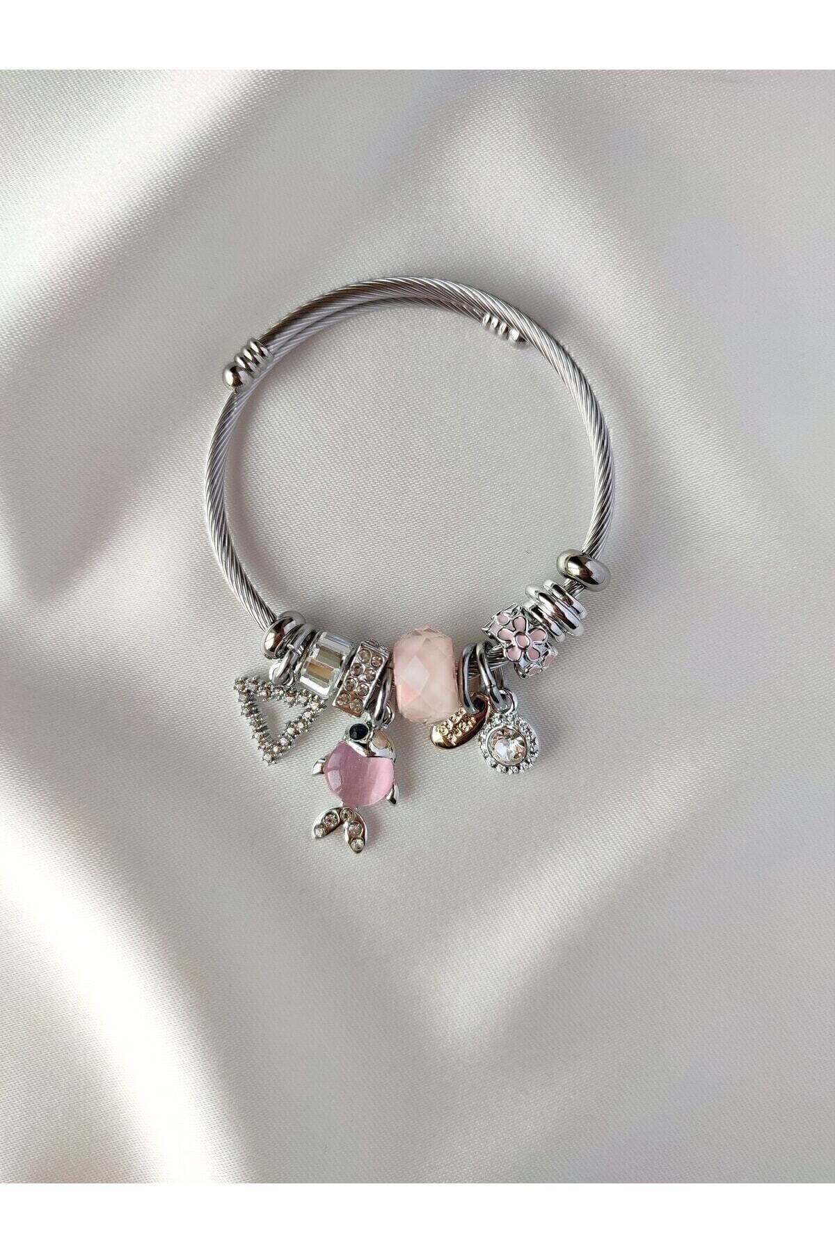 un bracelet dacier blanc avec un poisson rose sans garantie dacier