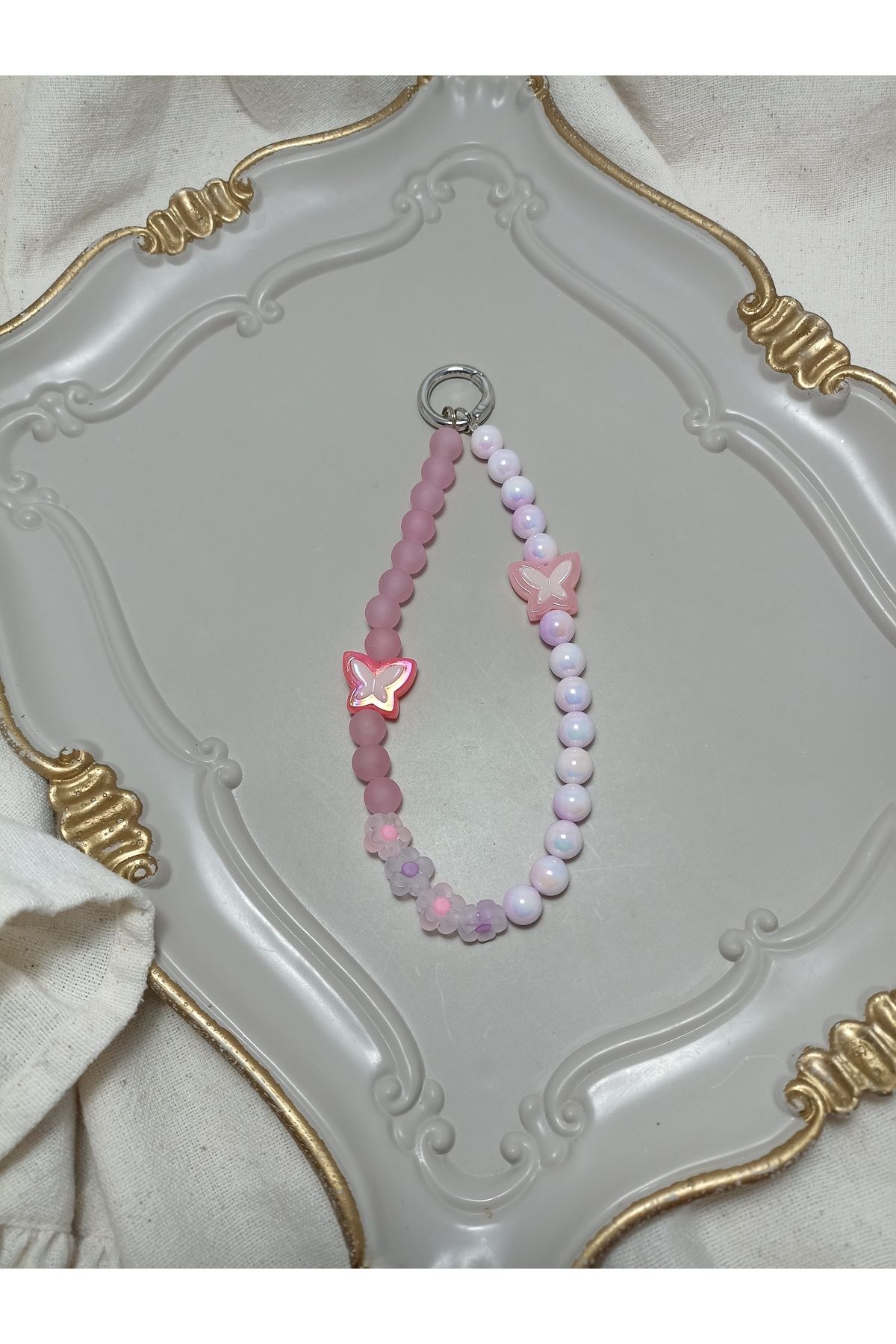 ida design store pembe inci ve kelebek detaylı telefon ve çanta charmı