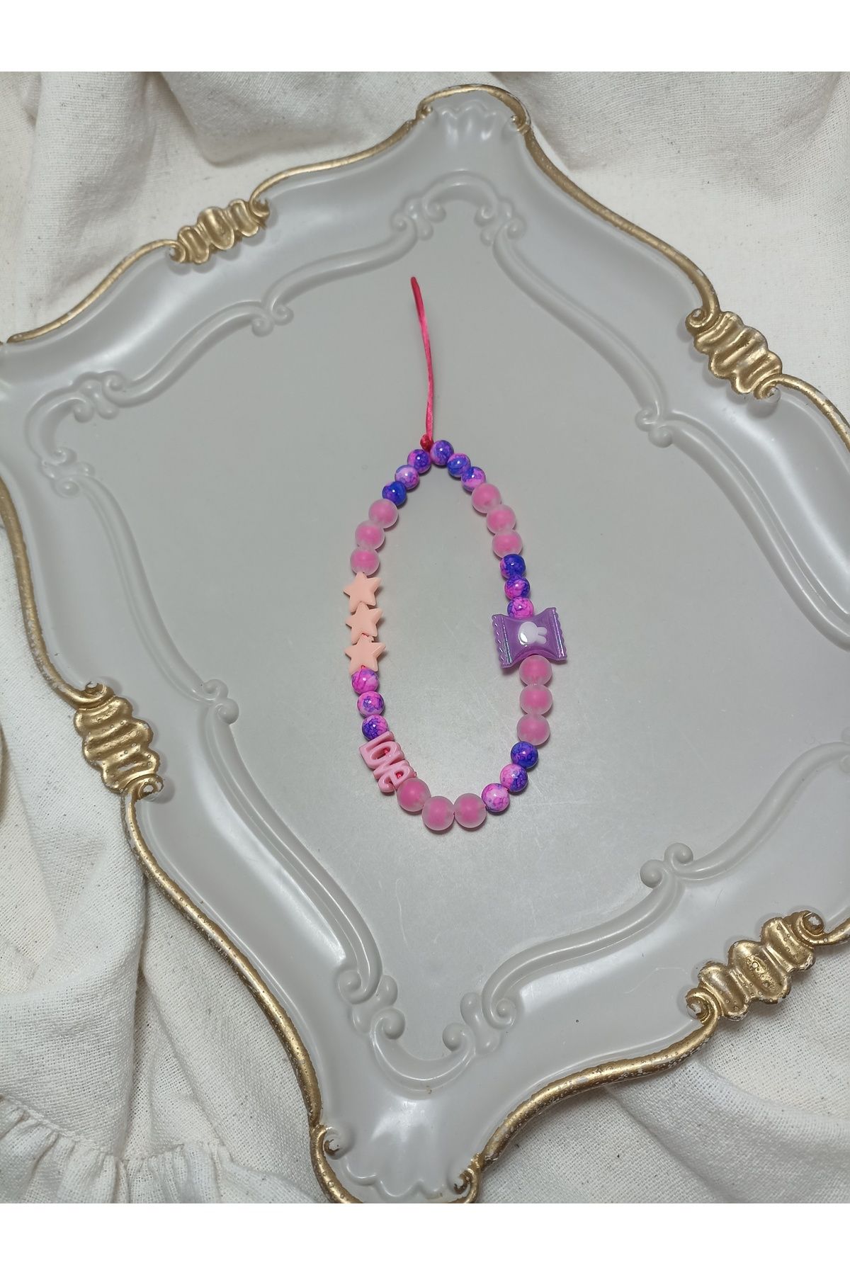 ida design store fuşya tonlarında boncuklar ile yıldız ve love detaylı çanta ve telefon charmı