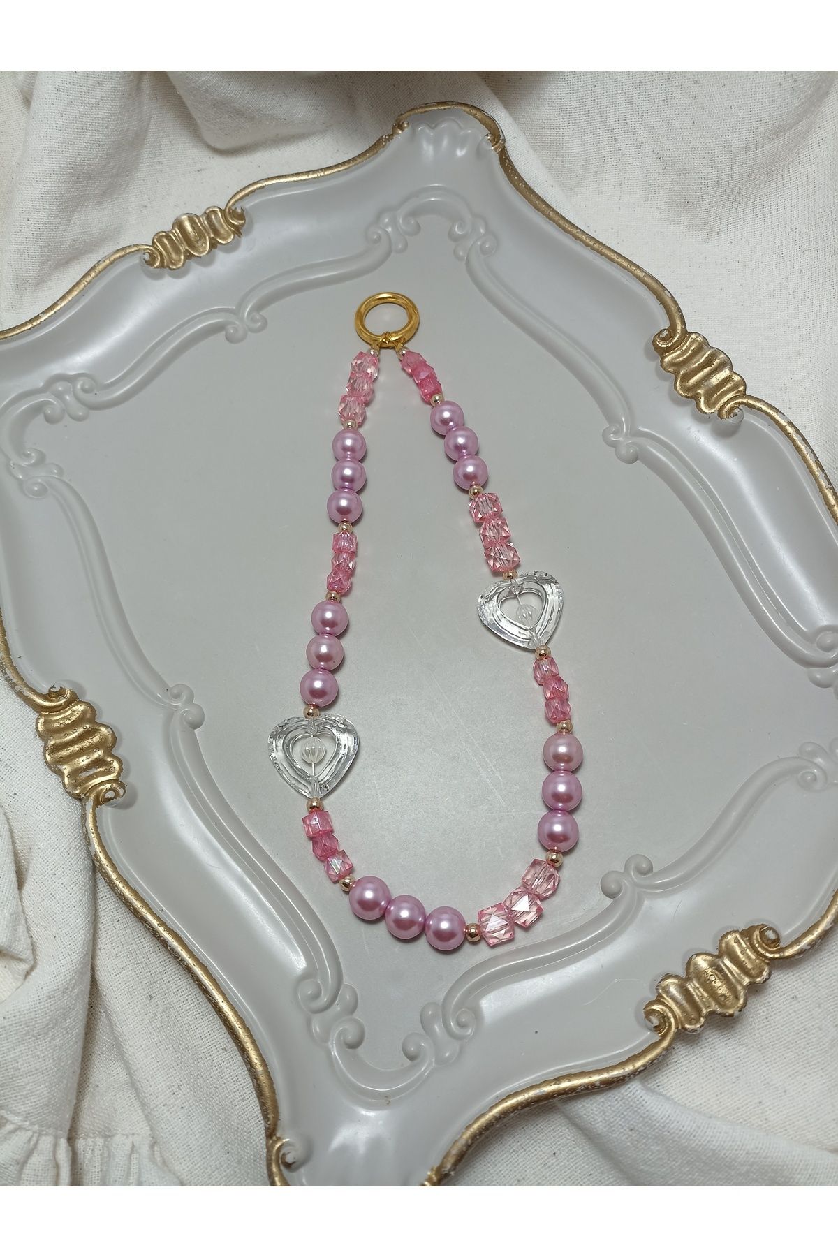 ida design store pembe inci ile gold ve kalp detaylı çanta ve telefon charmı