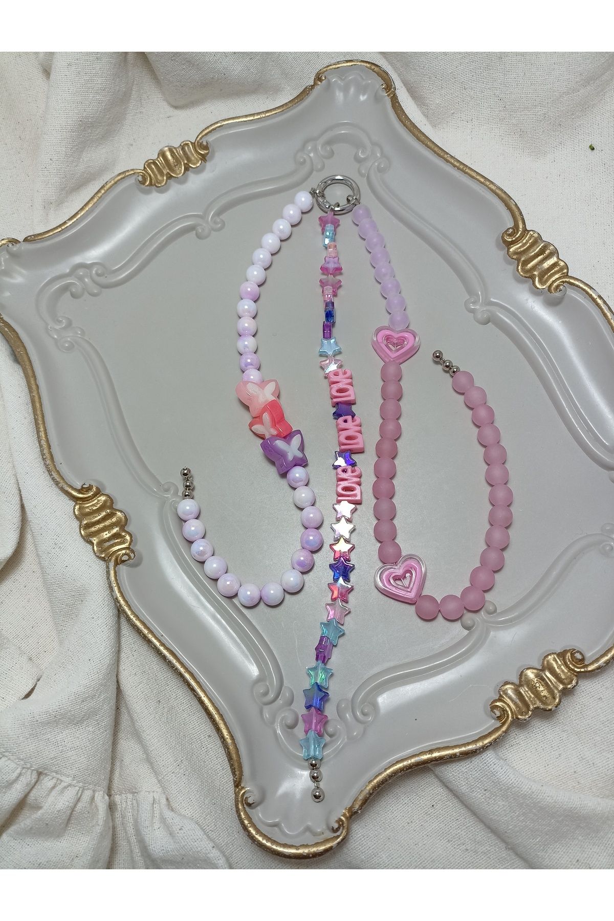 ida design store pembe ve mor tonlarında üç sarkıtlı çanta ve telefon charmı