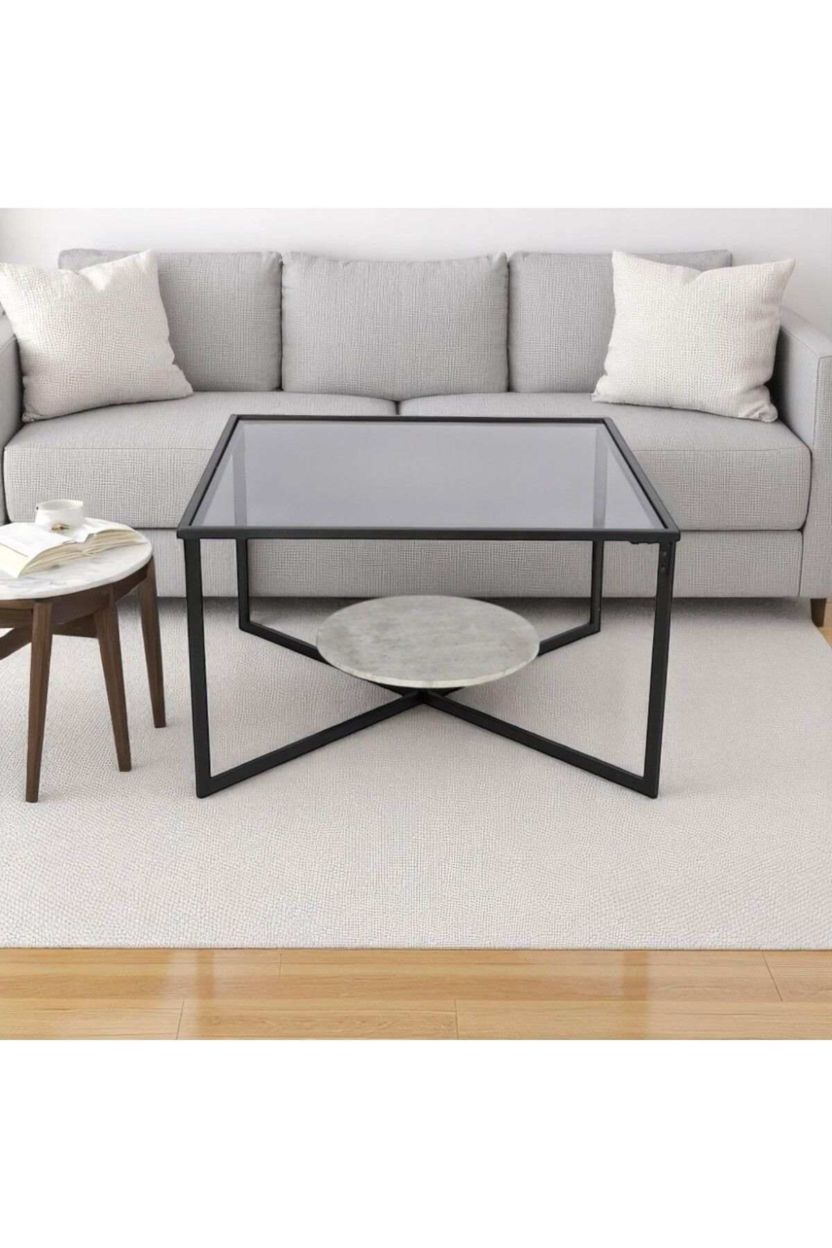 mr-everything-A square coffee table with a bold, modern design, combining a black glass top, a gray lower shelf, and a black metal base. 1