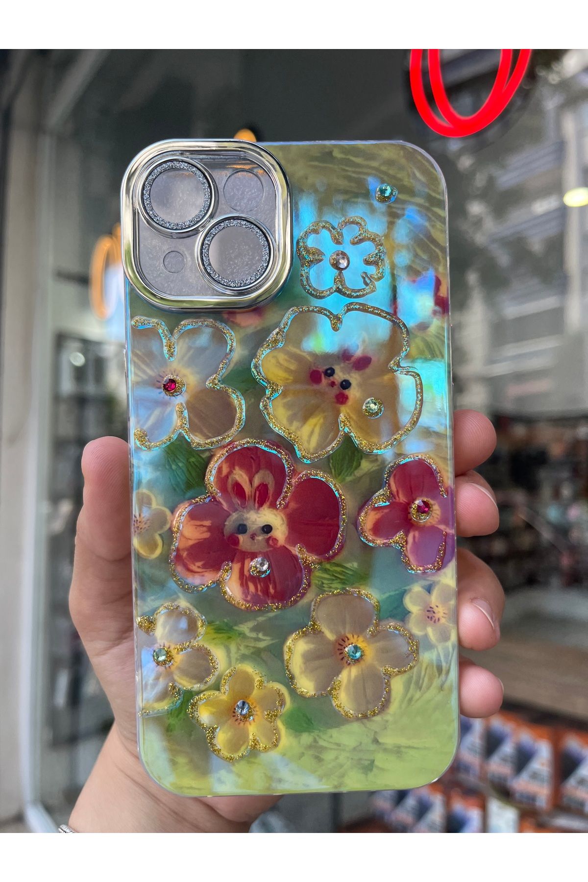 OVADA İPhone 13/14 Uyumlu Simli Kamera Korumalı Çiçek Desenli Taşlı Hologramlı Lüks Kılıf