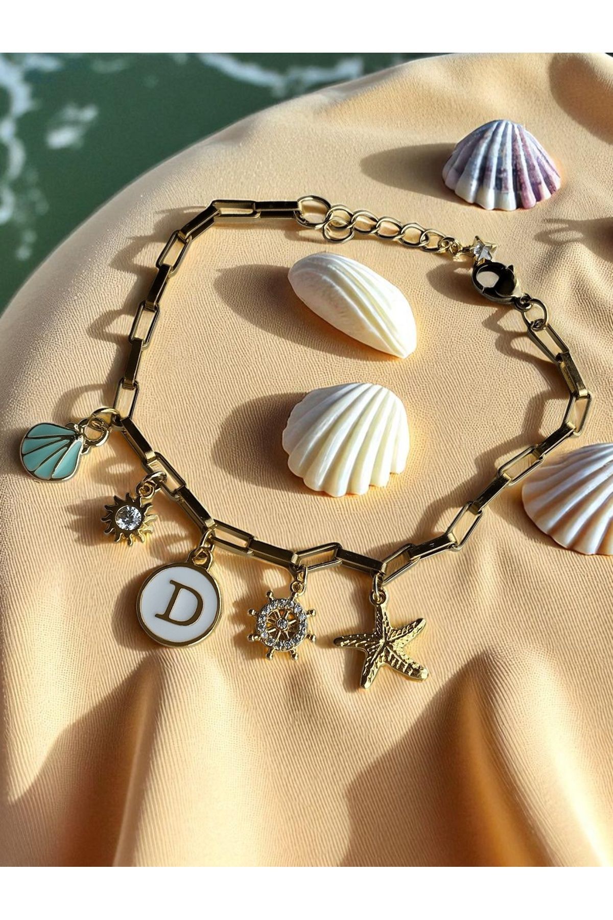 Amabel Jewelerys Zirkon Dümen, Harf, Güneş, Deniz Yıldızı ve Midye Kabuğu Detaylı Çelik Zincir Kadın Bileklik