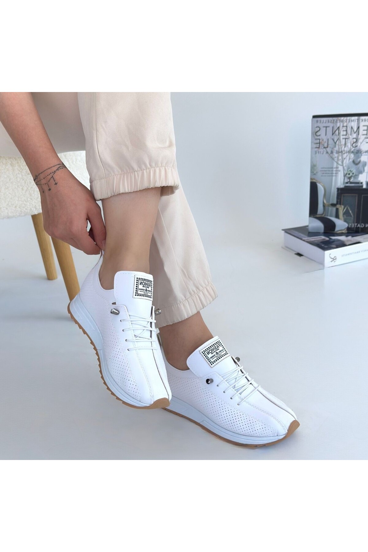 Production Women's Sports Shoes Against White Laced Orthopedic Heel Spur