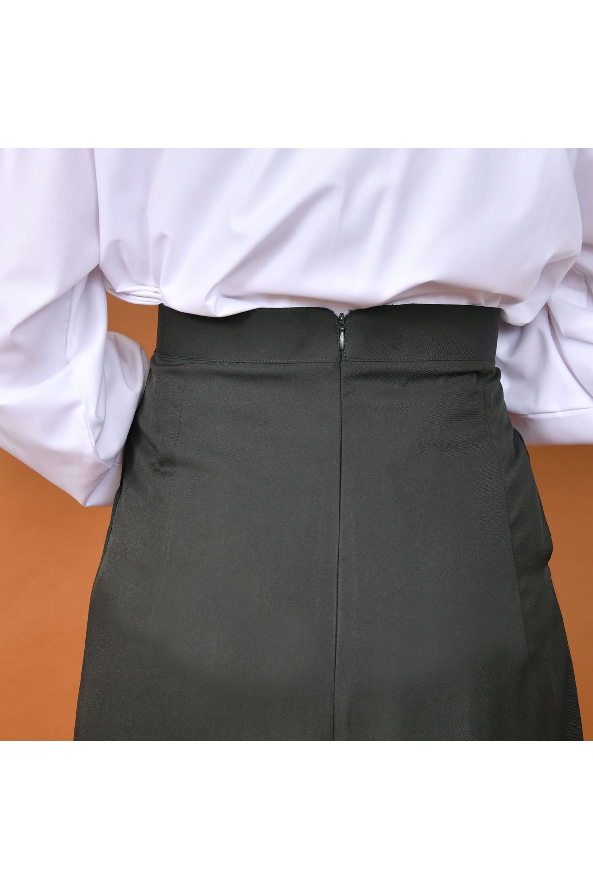 HAWRAA-A distinctively designed skirt with wide pleats and a side cut decorated with a button and hidden pockets (olive) 2
