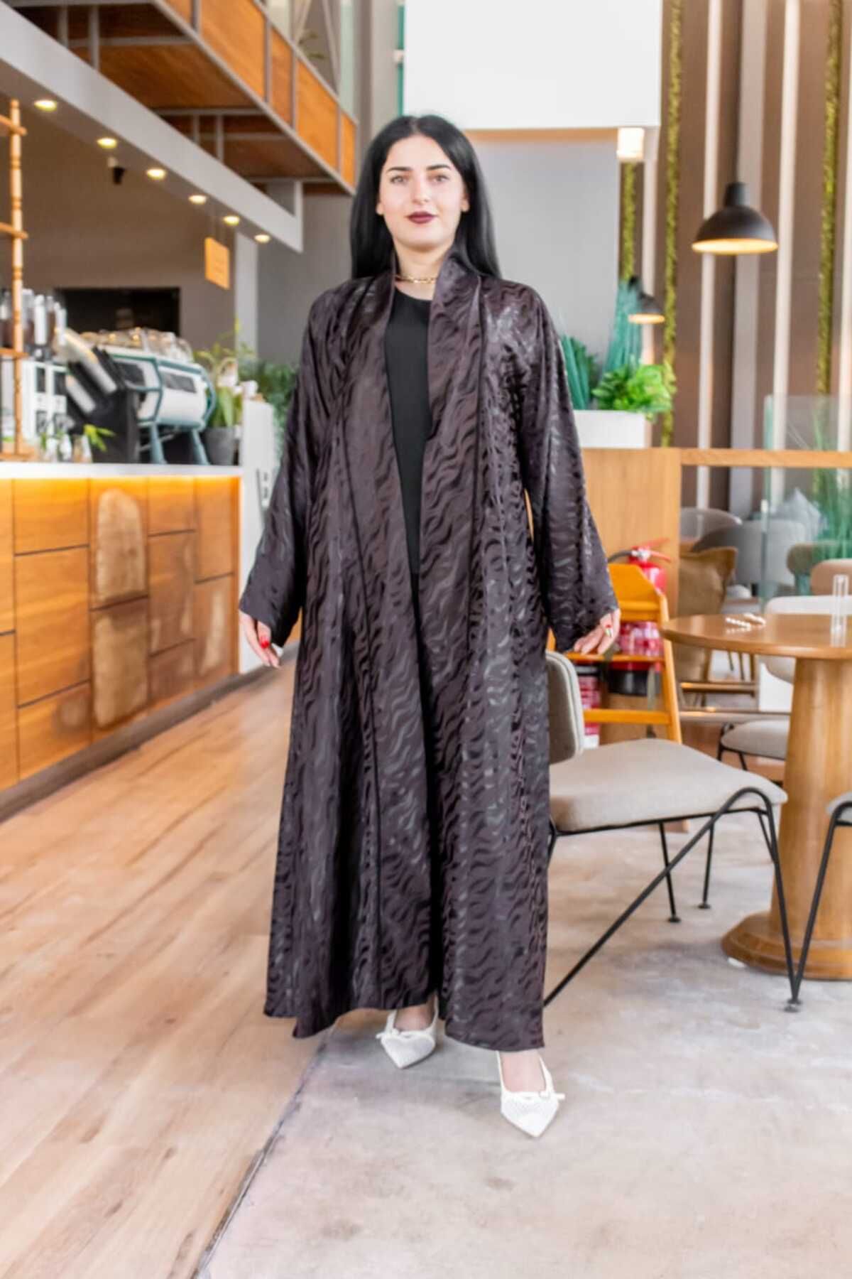 Lyaly aljlabyh-The Zebra Luxury is an elegant black abaya with a matte zebra print, featuring a loose, open design for a modern and bold look. 2