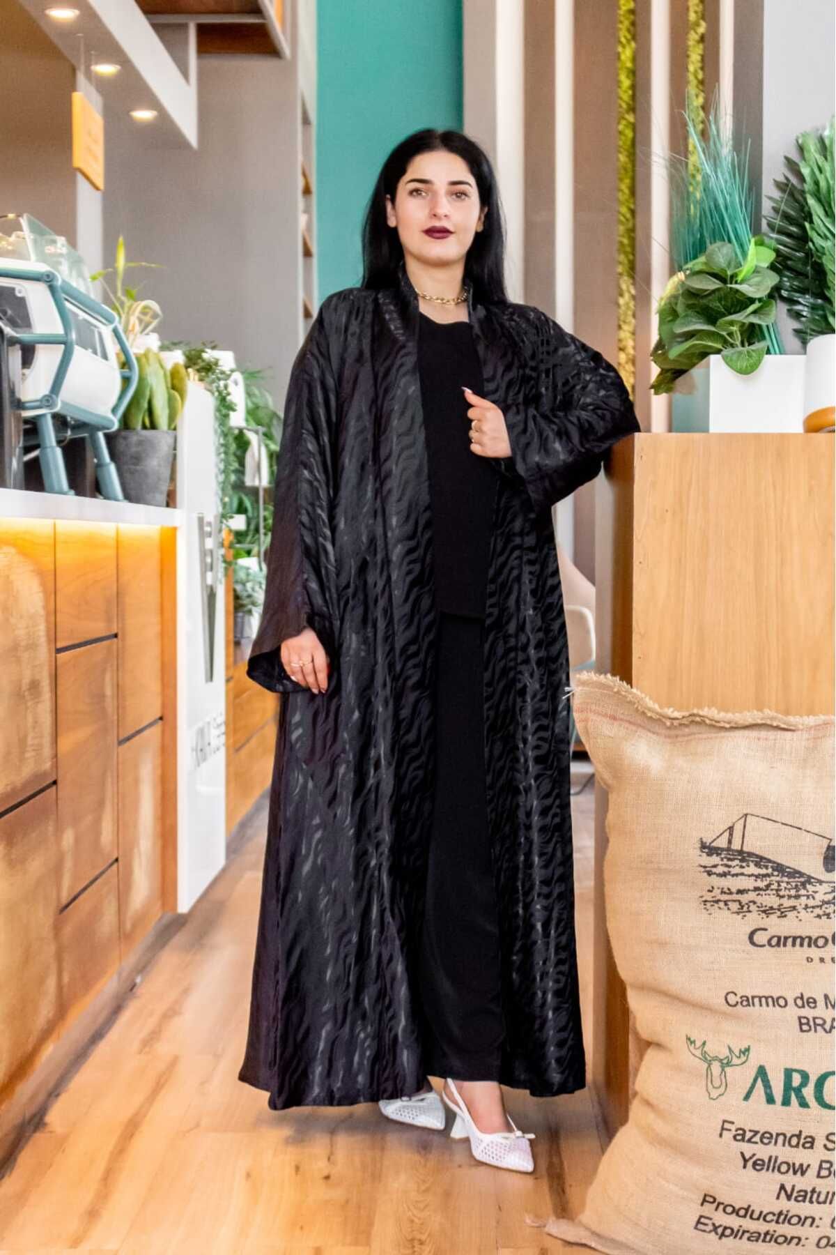 Lyaly aljlabyh-The Zebra Luxury is an elegant black abaya with a matte zebra print, featuring a loose, open design for a modern and bold look. 1
