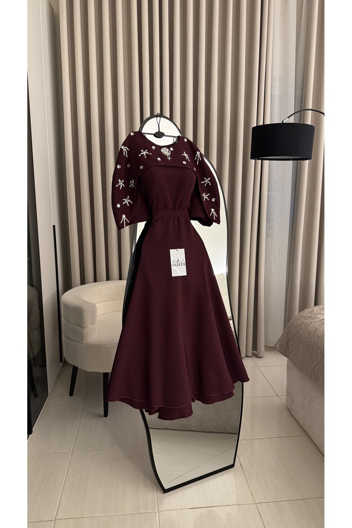 فستان سهرة أنيق بلون برغندي عميق، يتميز بقصة ناعمة...