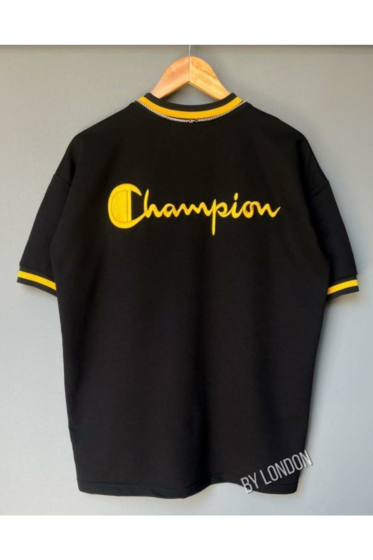 Black and yellow champion shirt 2025