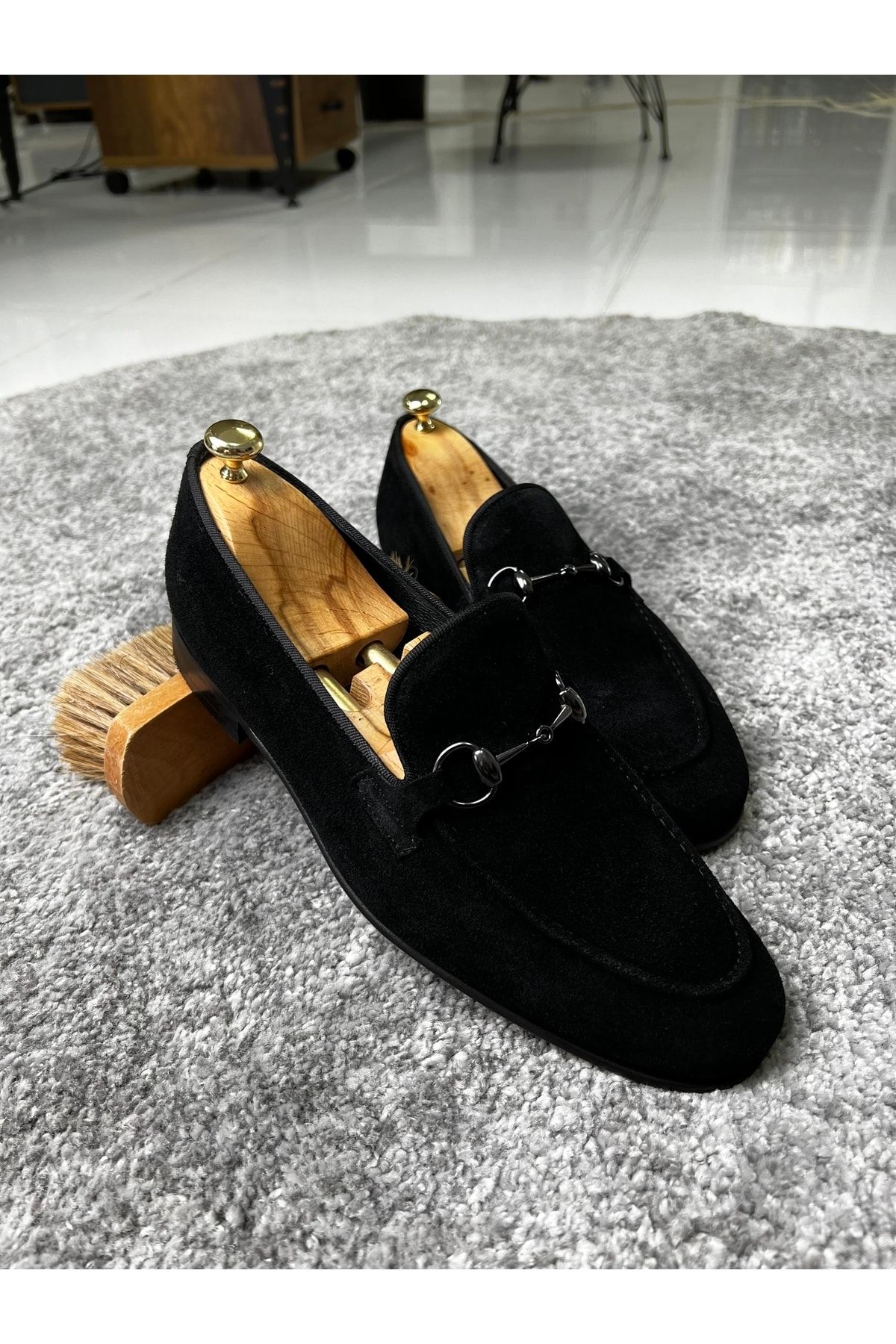 Black suede loafers with gold store buckle