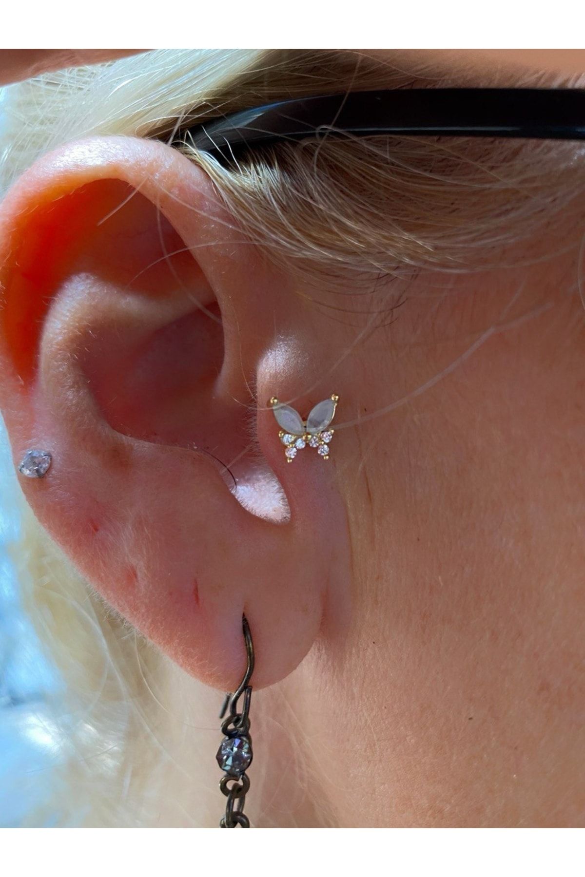 Butterfly shop tragus piercing
