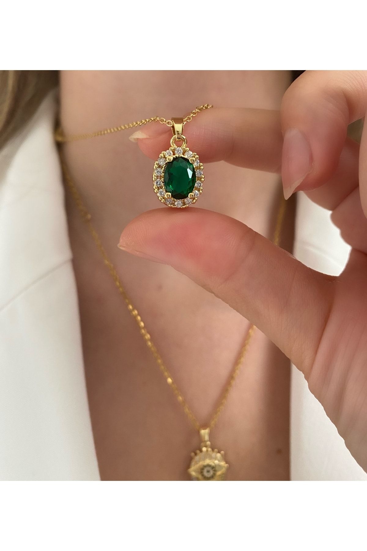 Gold necklace shop with emerald stone