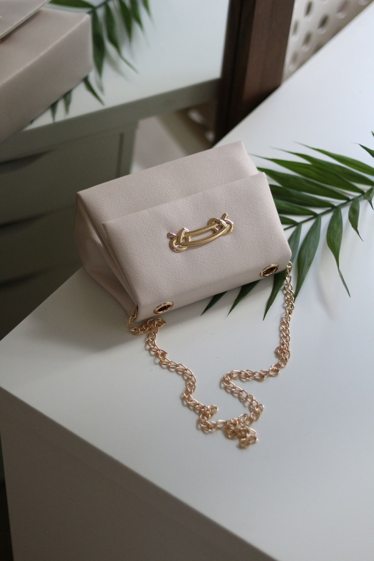 Cream bag store with gold chain