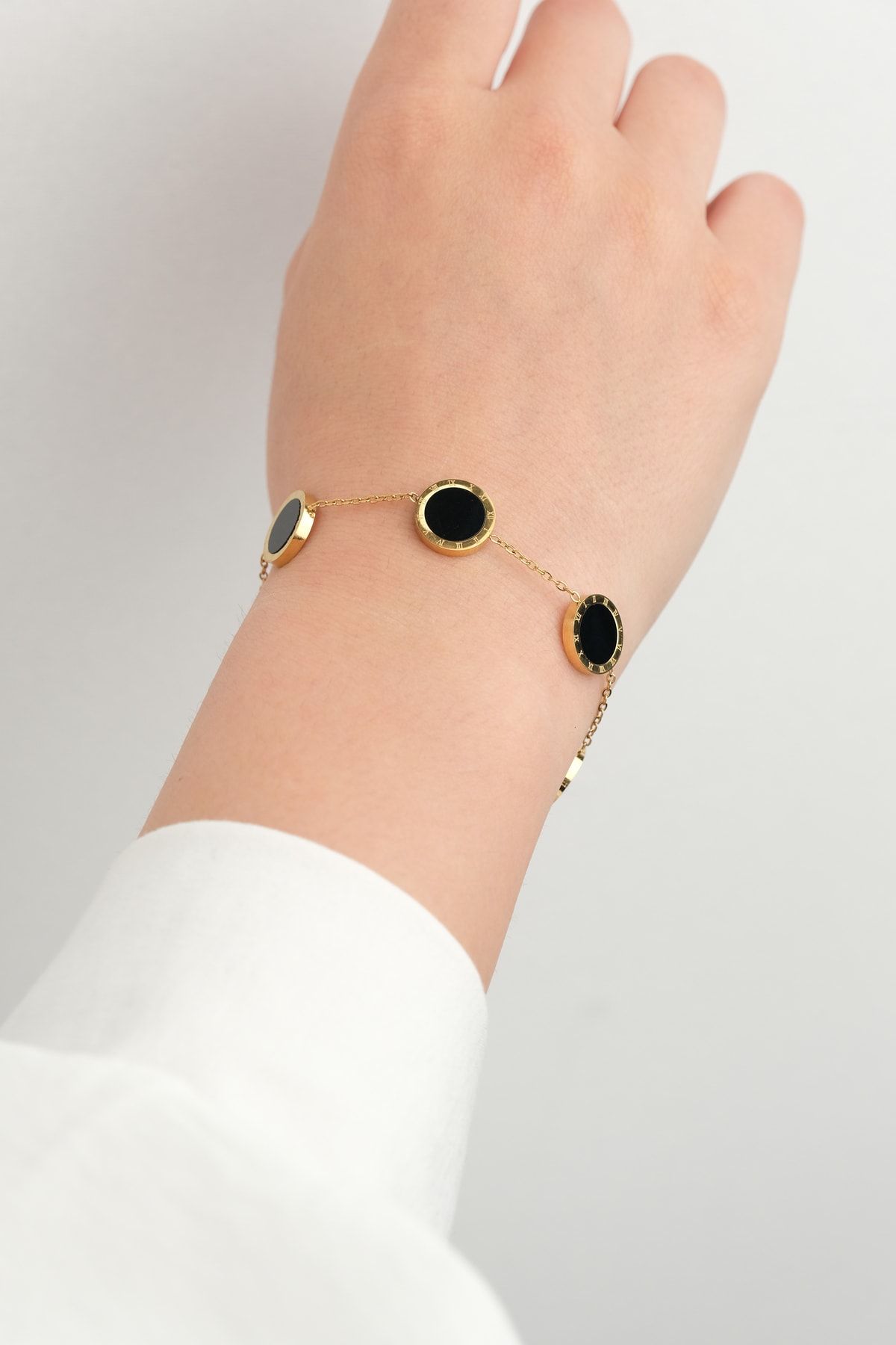 Black stone shop bracelet in gold
